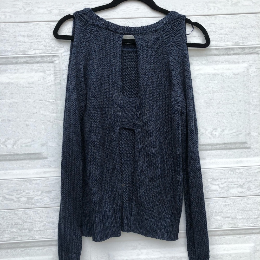 Navy blue sweater with cutouts.